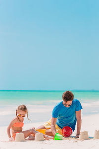 People on beach against sky