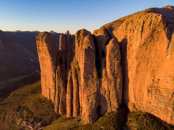 Panoramic view of rocky mountains against clear sky