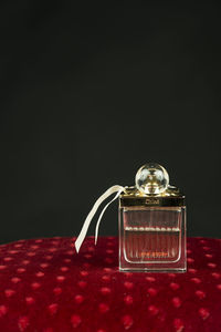 Close-up of glass jar on table against black background