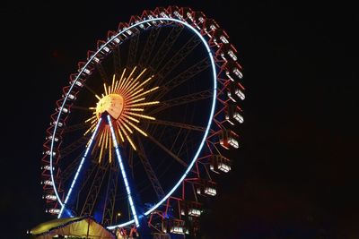 Low angle view of ferris wheel against sky at night