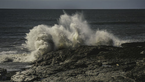 Waves breaking against sea