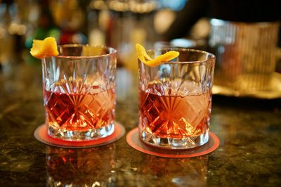 Close-up of negronis glasses on table