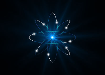 Close-up of abstract atom against black background