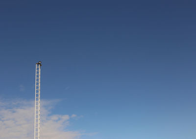 Low angle view of tower against blue sky