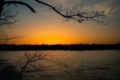 Scenic view of lake against orange sky