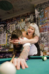 Young couple playing pool