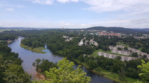 High angle view of river amidst trees against sky