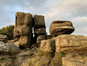 Low angle view of rocks on rock against sky
