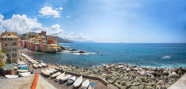 Panoramic view of sea and buildings against sky