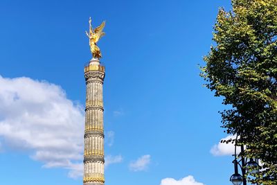 Low angle view of statue against blue sky