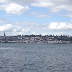 River in city against cloudy sky