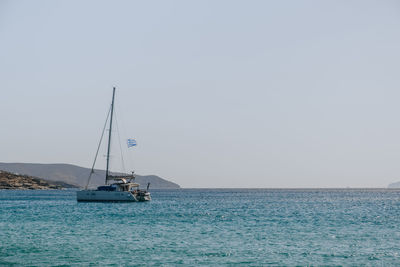 Sailboat sailing on sea against clear sky