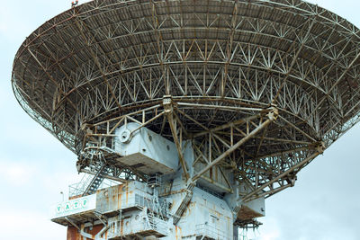 Low angle view of communications tower against sky