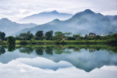 Scenic view of lake and mountains against sky