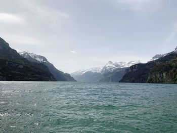 Scenic view of sea and mountains against sky. italian lake of iseo.