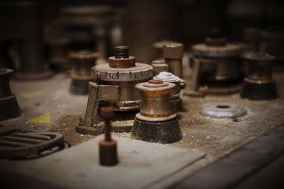 Close-up of old machine part on table
