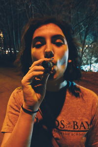 Portrait of mid adult man smoking sign