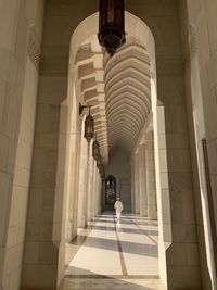 Low angle view of woman walking in corridor of building