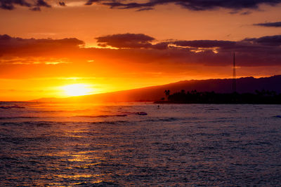 Scenic view of sea against romantic sky at sunset