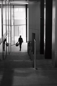 Reflection of woman in glass of building