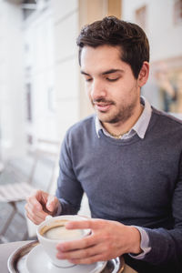 Close-up of man holding coffee cup