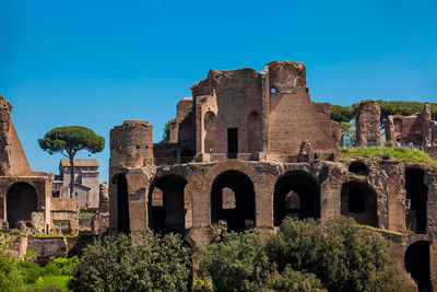 Low angle view of historical building against clear blue sky