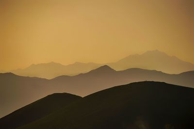 Scenic view of silhouette mountains against sky during sunset