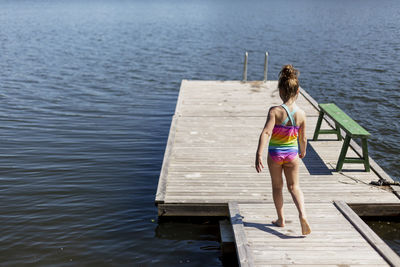 Rear view of girl on jetty