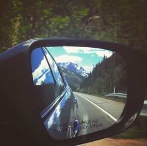 Reflection of road on side-view mirror of car