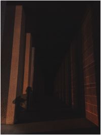 Empty narrow alley along pillars