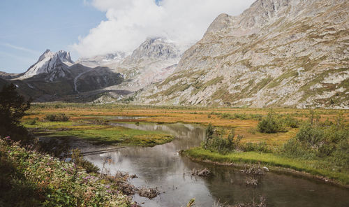 Scenic view of lake and mountains against sky