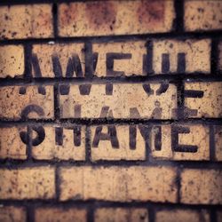 Text on brick wall