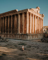 High angle view of woman standing by historical building