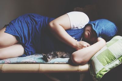 High angle view of siblings sleeping on bed at home
