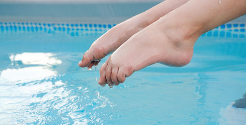 Low section of woman in swimming pool