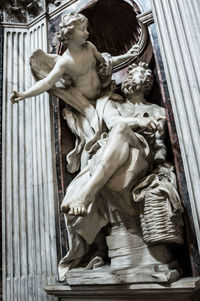 Low angle view of statue against building