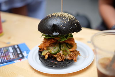 Burger served in plate on table at restaurant