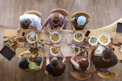 High angle view of people eating food on table