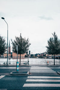 Empty road with trees in background