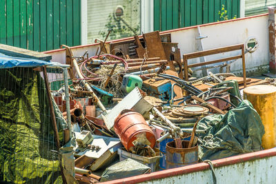 Garbage, scrap and waste in an ugly dirty garbage container on a no longer seaworthy ship 