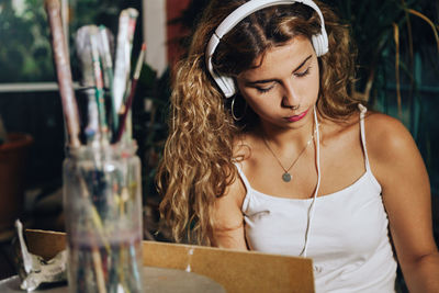 Woman listening music while sitting at home