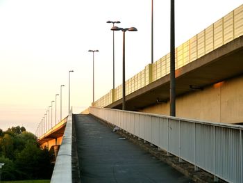 Narrow footbridge against clear sky