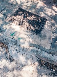 High angle view of text on wet street