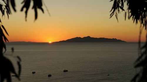 Scenic view of sea against clear sky during sunset