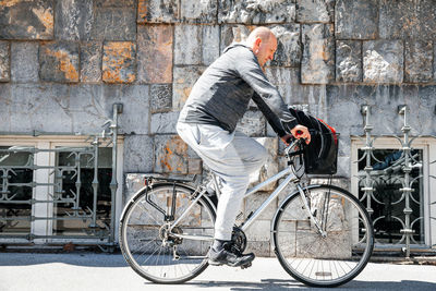 Portrait of a handsome hipster man. a man in a big city cycling down the street on a bicycle