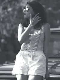 Woman standing by car