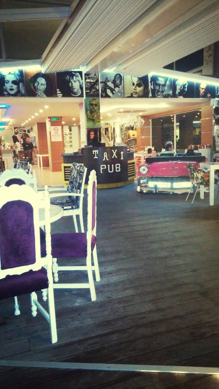 indoors, table, communication, chair, text, restaurant, absence, western script, window, empty, sitting, glass - material, seat, reflection, book, transportation, wood - material, incidental people