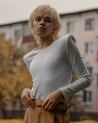 Young woman standing against built structure