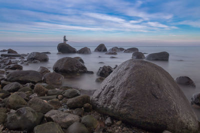 Scenic view of sea against cloudy sky