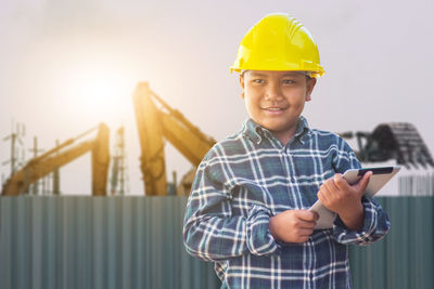 Portrait of smiling boy holding mobile phone